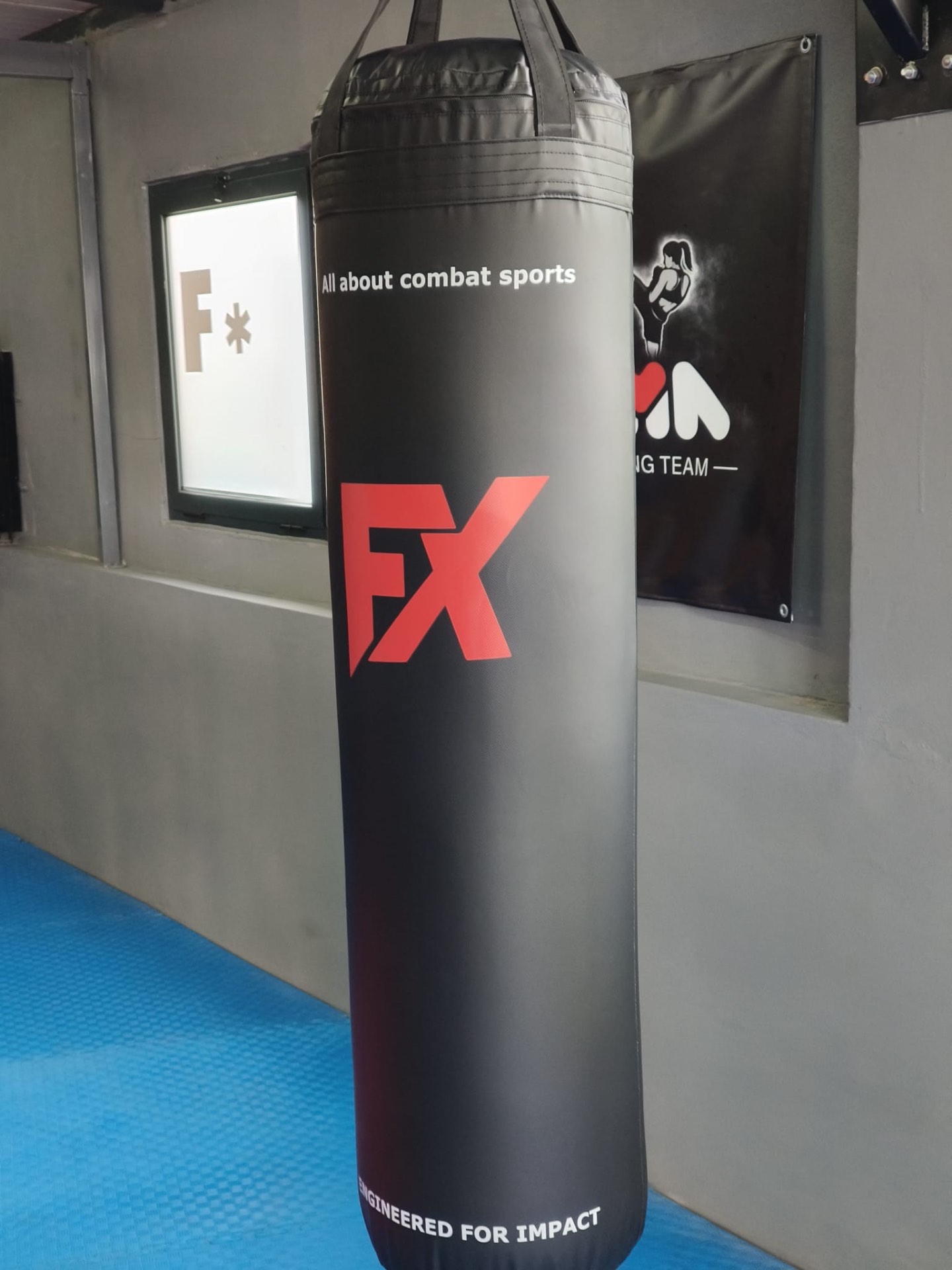 Front view of a black FX heavy bag with white lettering