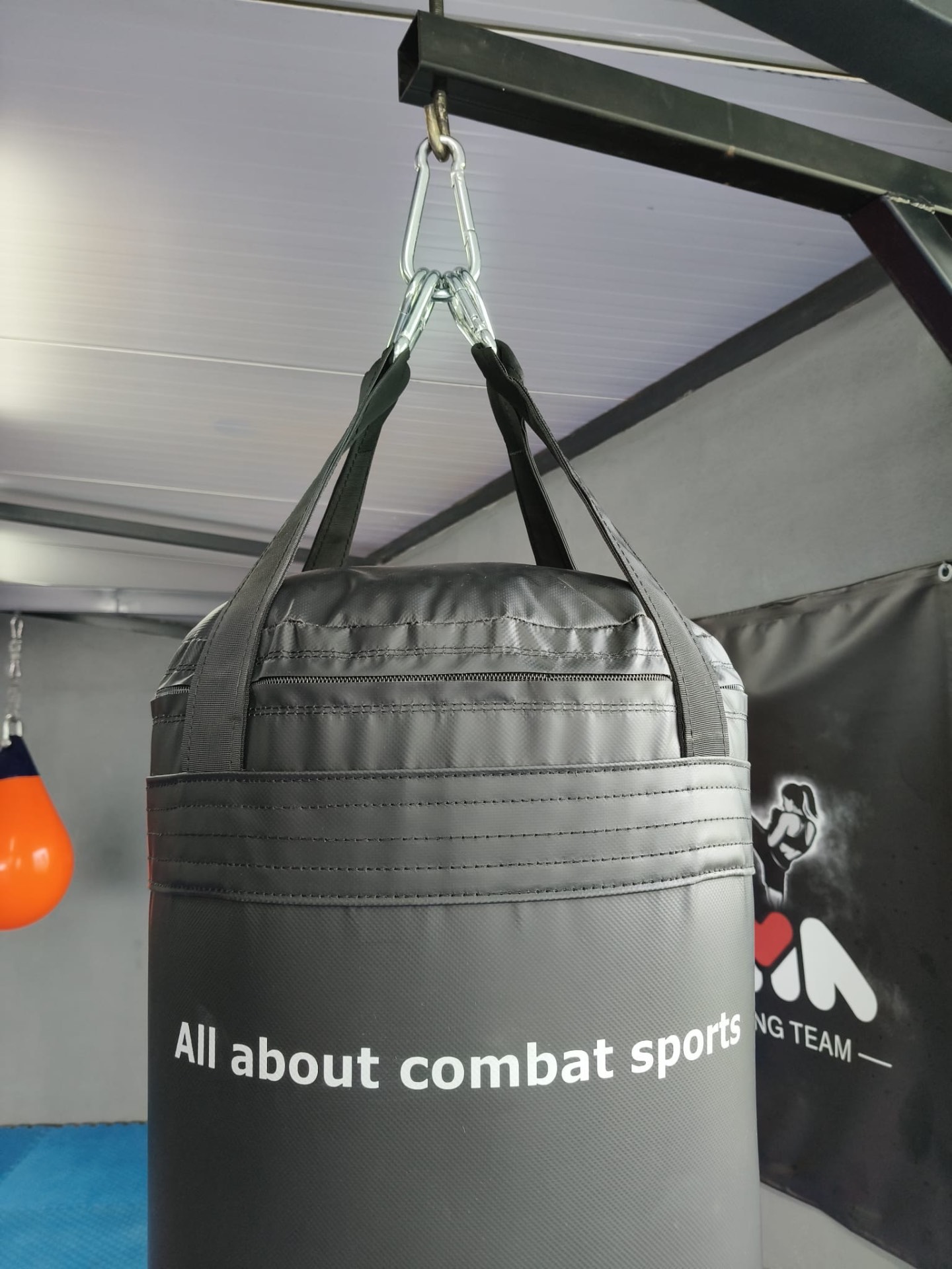 Straps and steel carabiners holding an FX bag