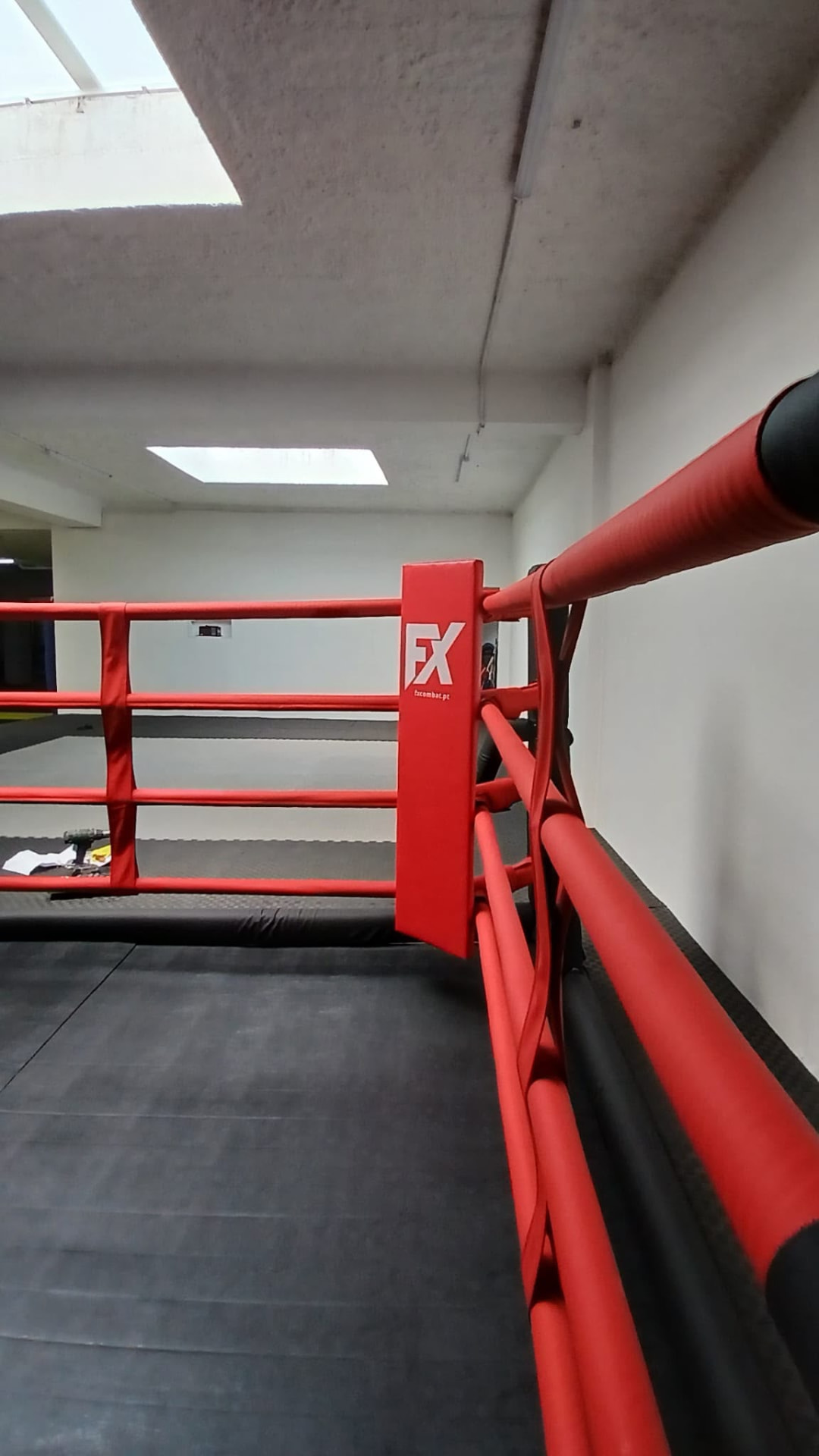 Red covered ropes and FX corner seen from inside the ring