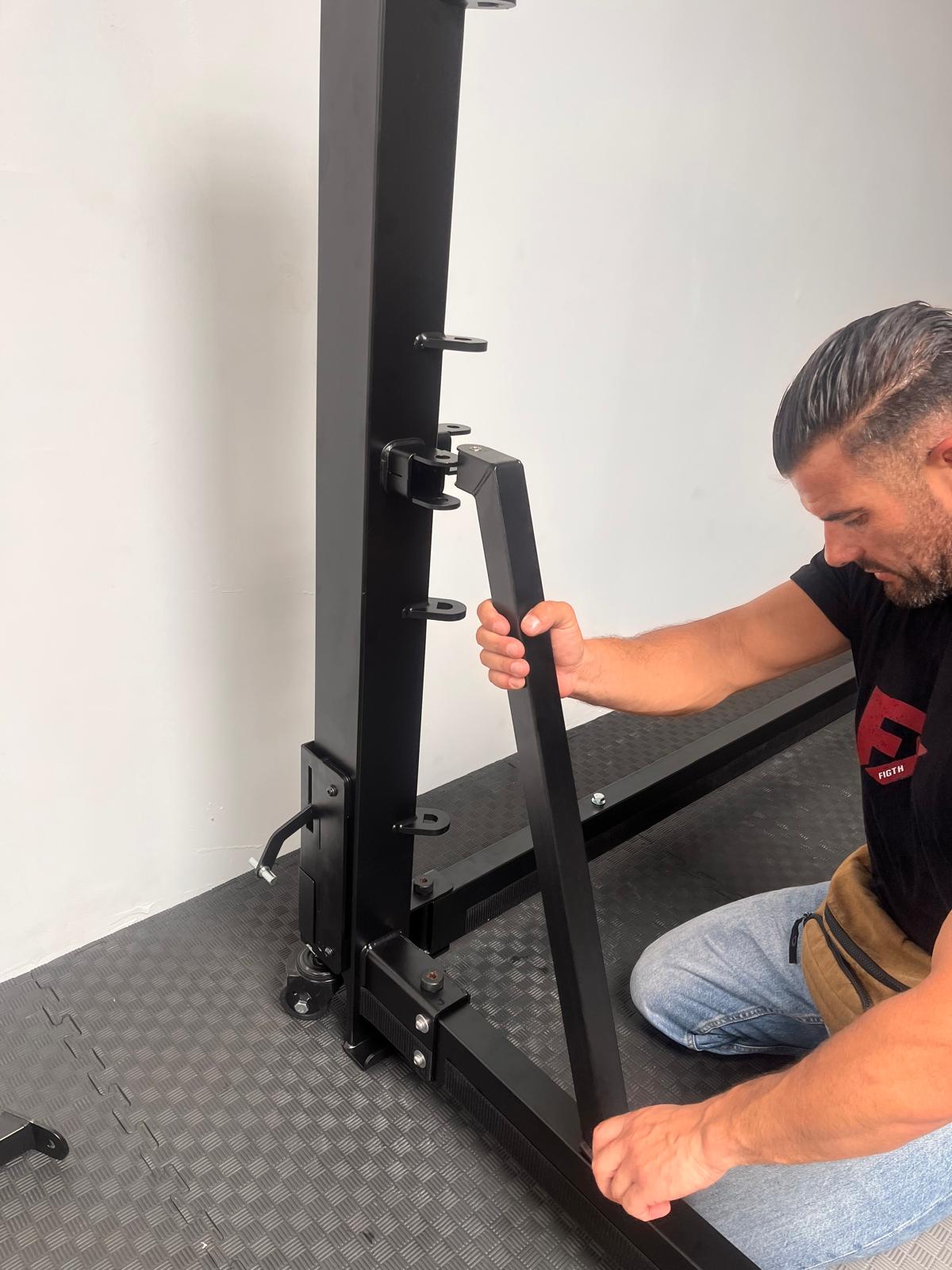 FX technician assembling the post and arm of a foldable ring