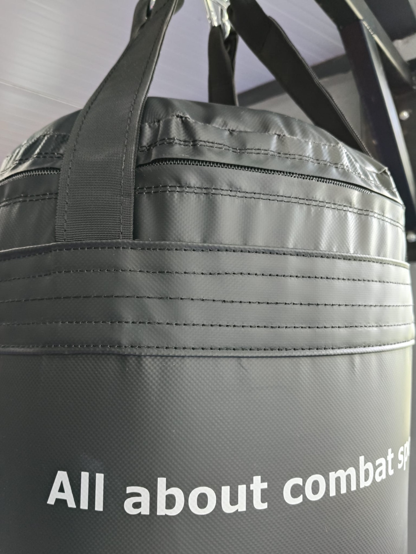 Close-up of multiple stitching rows and zip on top of an FX bag